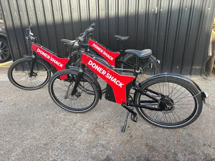 A row of Doner Shack-liveried electric bikes ready for delivery